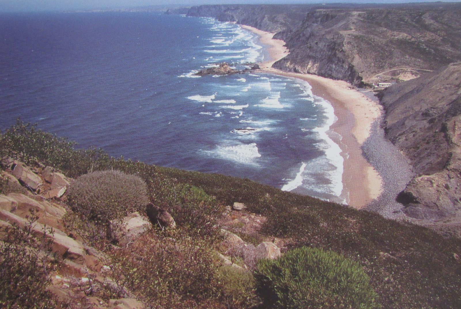 Praia do Castelejo, in Vila do Bispo, between dark cliffs and golden sand